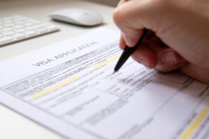 document, white table with computer keyboard and a mouse in background